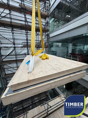 Crane lifting wooden panels