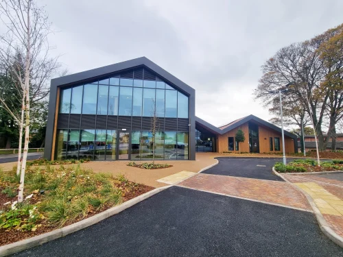 A grey building with a plethora of windows 