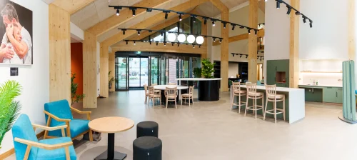 A timber arched room with modern furniture in and around the room.