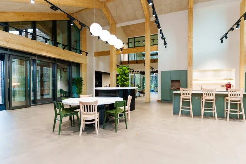 A timber arched room with modern furniture in and around the room.