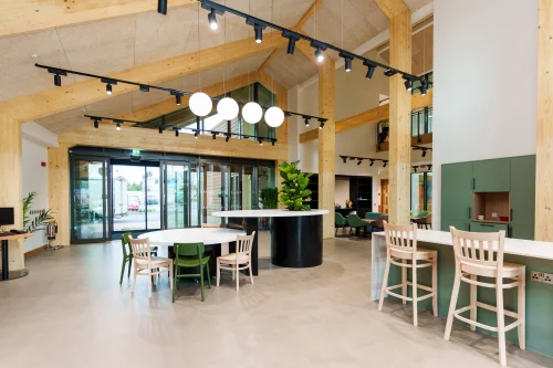 A timber arched room with modern furniture in and around the room.